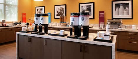 A modern coffee station with multiple coffee makers and a variety of coffee cups and containers.