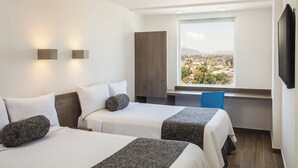A hotel room with two beds, a large window with a city view, a flat-screen TV, and a blue chair. - One Ciudad de Mexico La Raza (Mexico City)