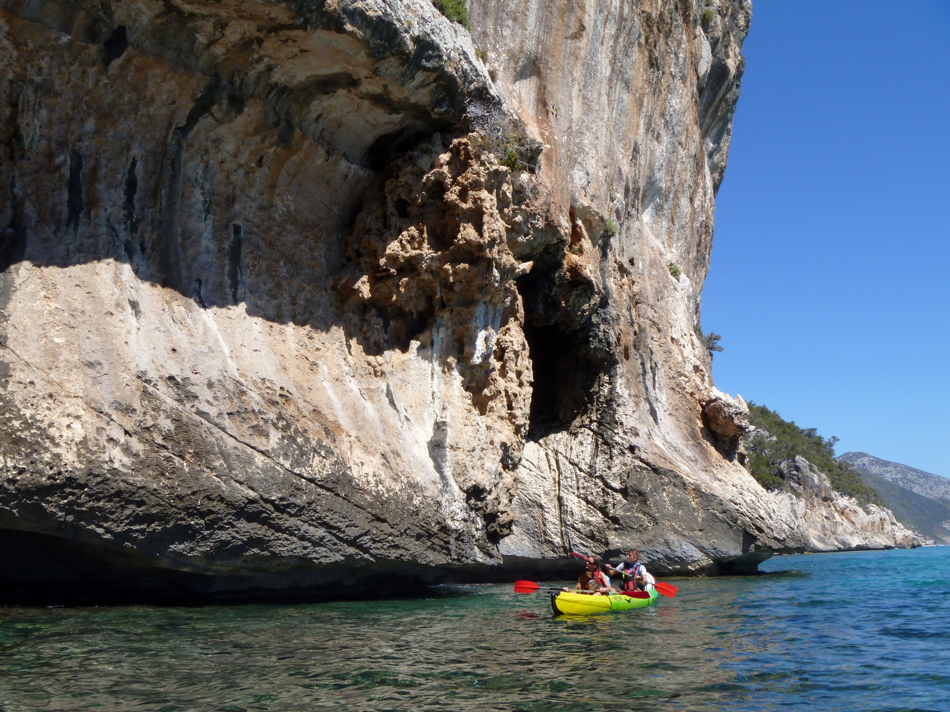 A rocky coastline with a clear blue sea.