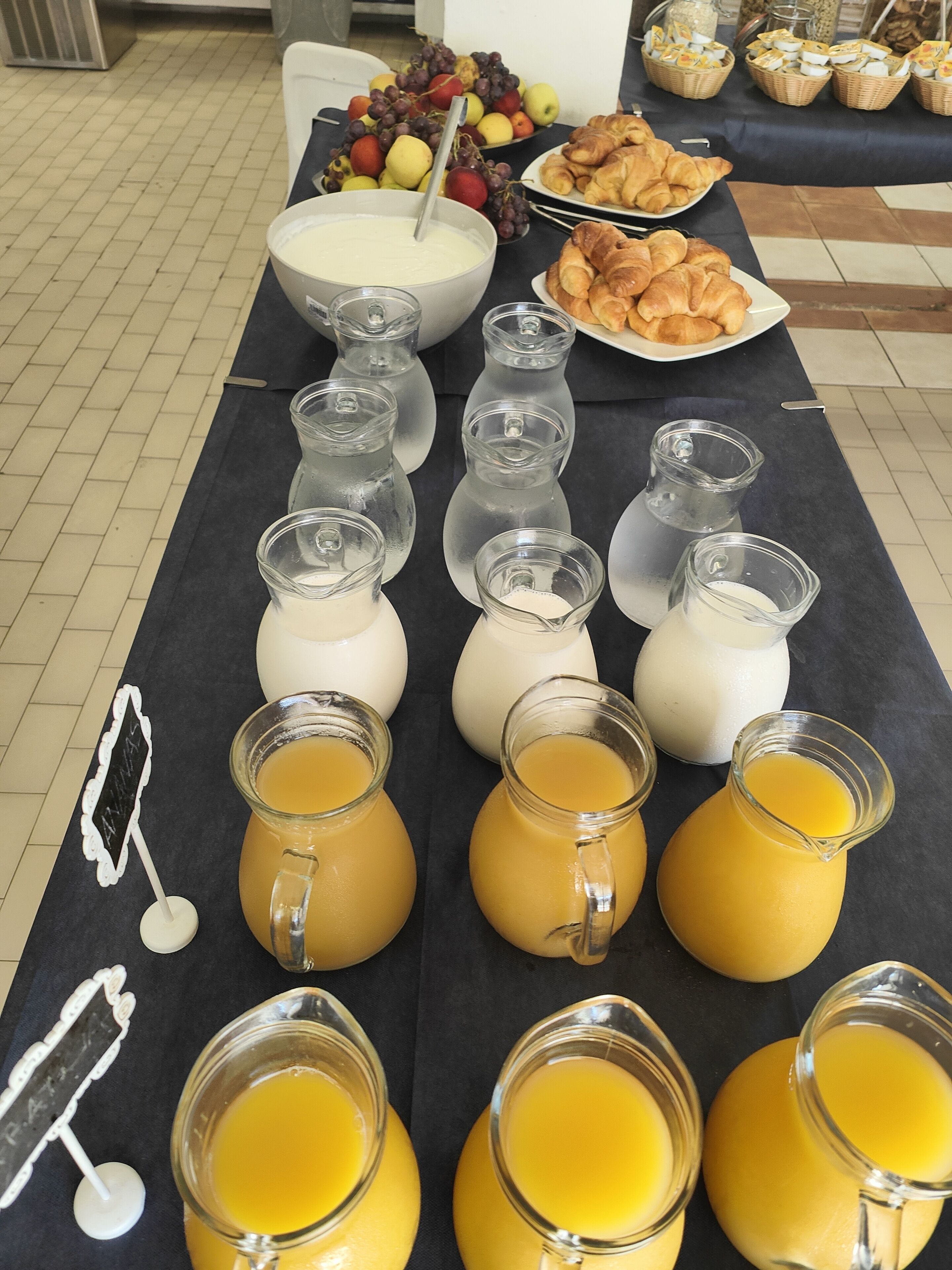 A breakfast buffet with various food items and beverages.