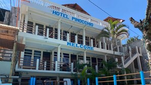 Un hotel llamado 'Hotel Pinocchio' con una piscina delantera.