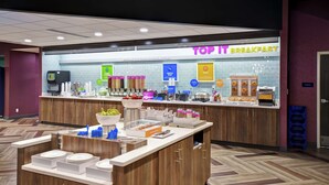 A breakfast area with a counter displaying various food items and a sign that reads "TOP IT BREAKFAST". - Tru by Hilton Fort Wayne, IN (Fort Wayne)