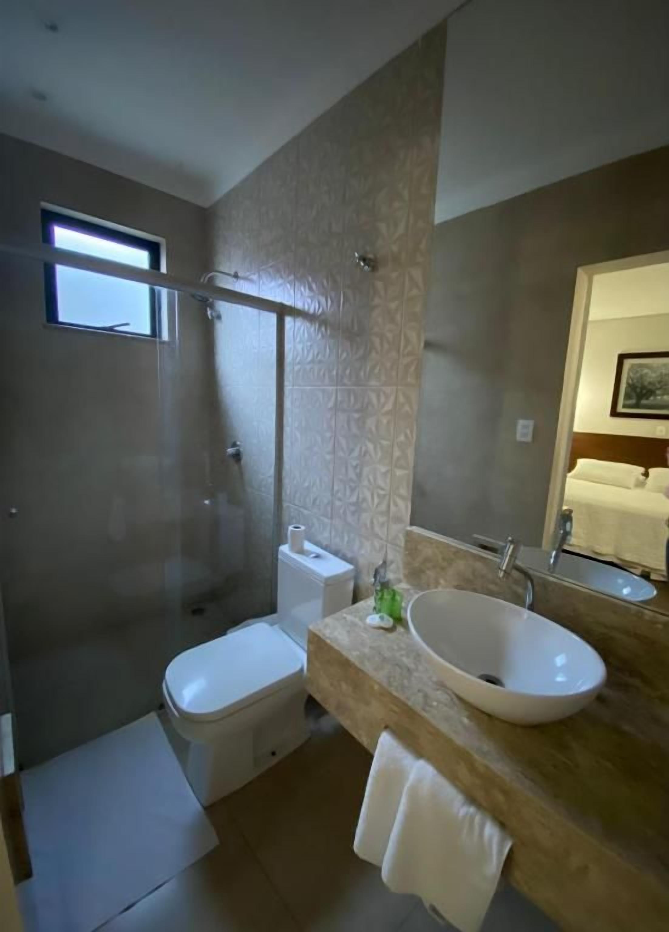 A bathroom with a bathtub, toilet, and sink.