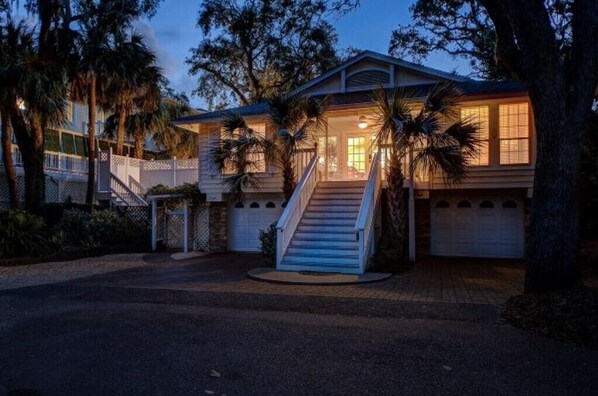 A two-story house with a front porch, a staircase, and a garage.