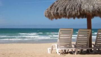 On the beach, sun loungers, beach towels