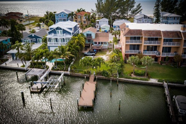A coastal residential area with houses, a dock, and a marina.