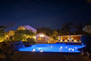 Outdoor pool, a waterfall pool, pool umbrellas, pool loungers