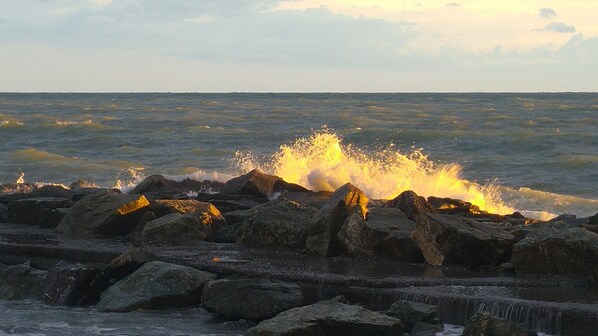 Enjoy the soothing sound of waves crashing against the rocky shoreline.