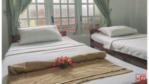 A room with two beds, a window with curtains, and a number 17 sign. - No17 Residence (Kandy)