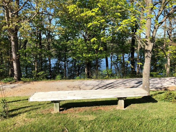 A wooden bench in a park with a lake in the background. - Beautiful Vacation Home on Lake Cumberland, Monticello, KY (Monticello)