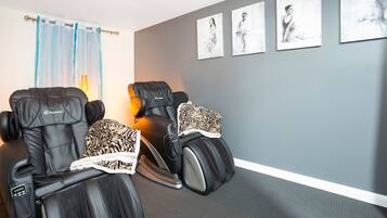 Relax in style with two massage chairs and soothing artwork.