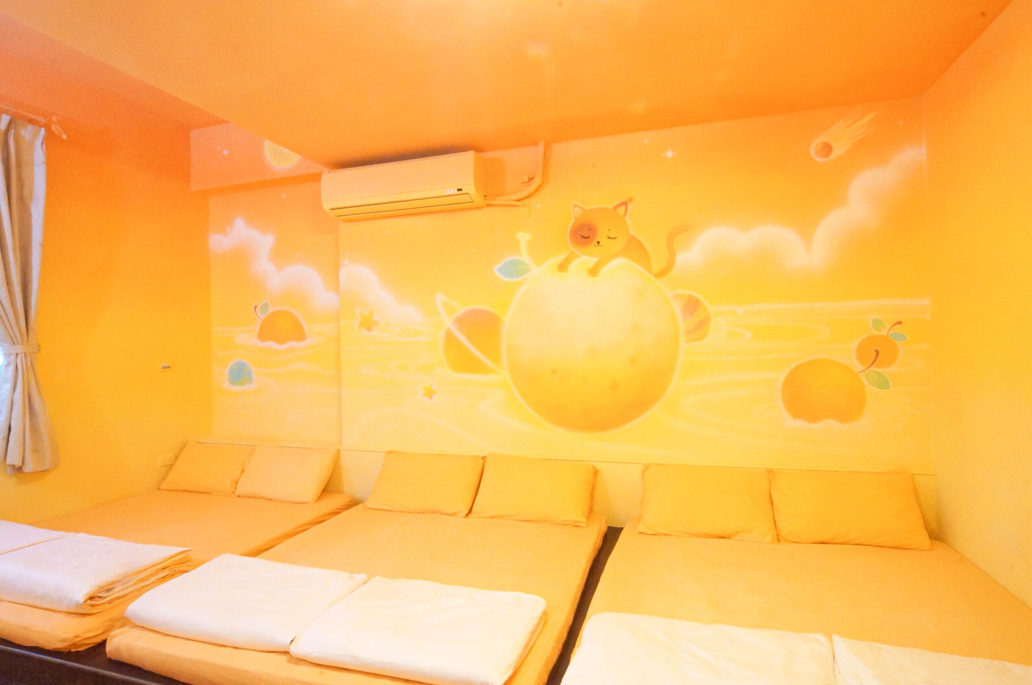 A room with a bed, a wall mural, and an air conditioning unit.