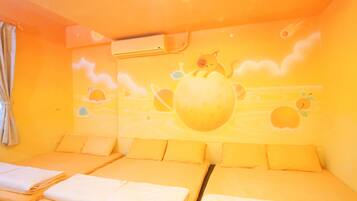 A room with a bed, a wall mural, and an air conditioning unit.
