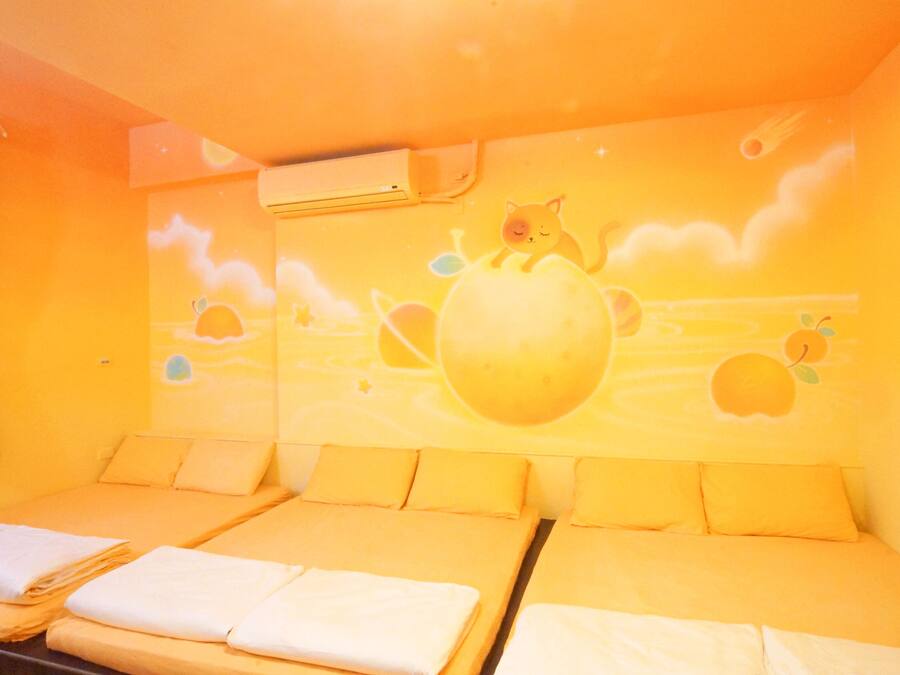 A room with a bed, a wall mural, and an air conditioning unit.