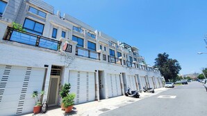 A modern multi-story building with large windows and a flat roof. - Suiian inn  (Hengchun)