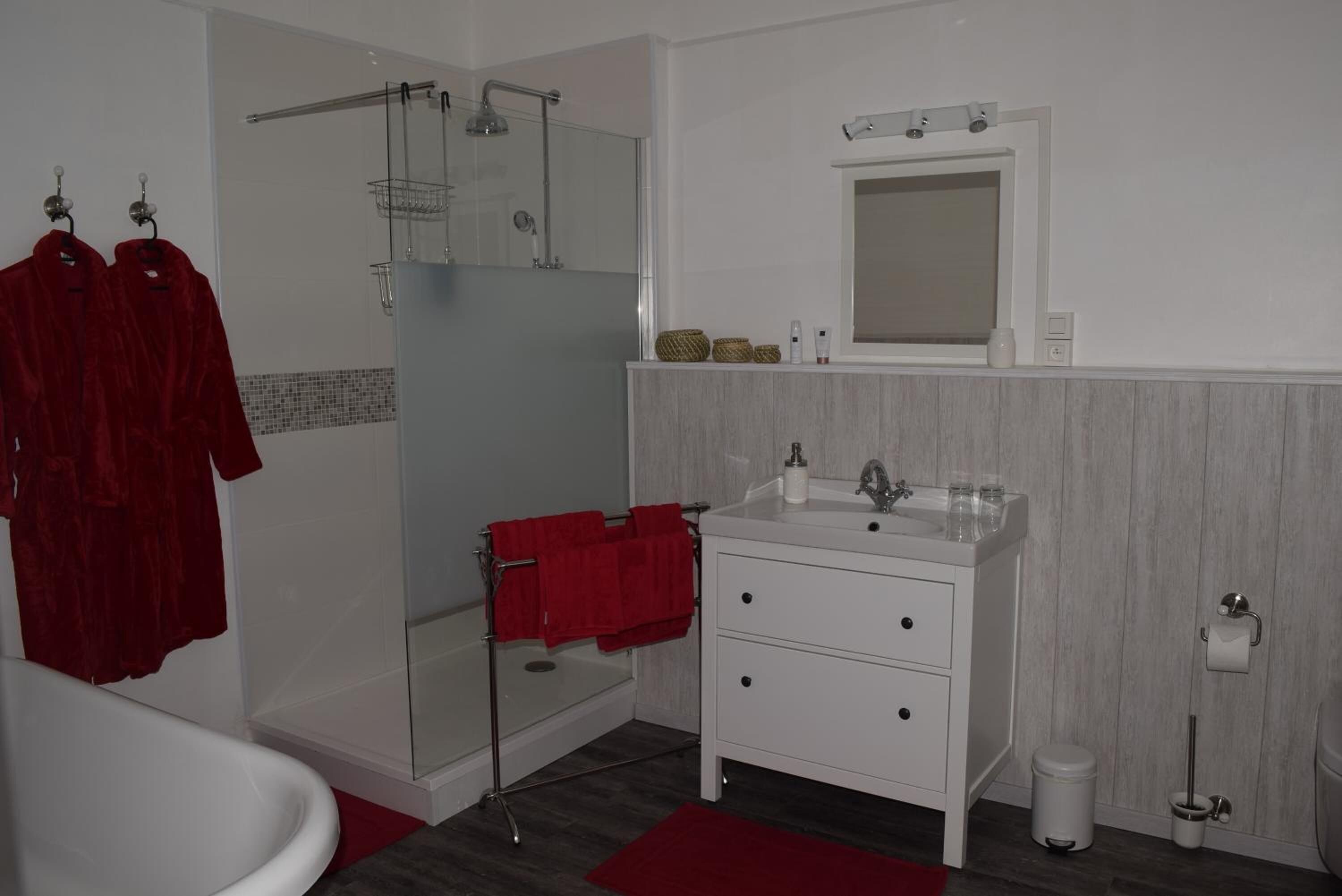 A bathroom with a shower, a sink, and a toilet.