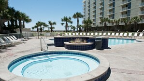 A swimming pool with lounge chairs and palm trees. - Beautiful Views, 4 Bedroom Gulf Front with 2 Master Suites, Sleeps 12 (Miramar Beach)