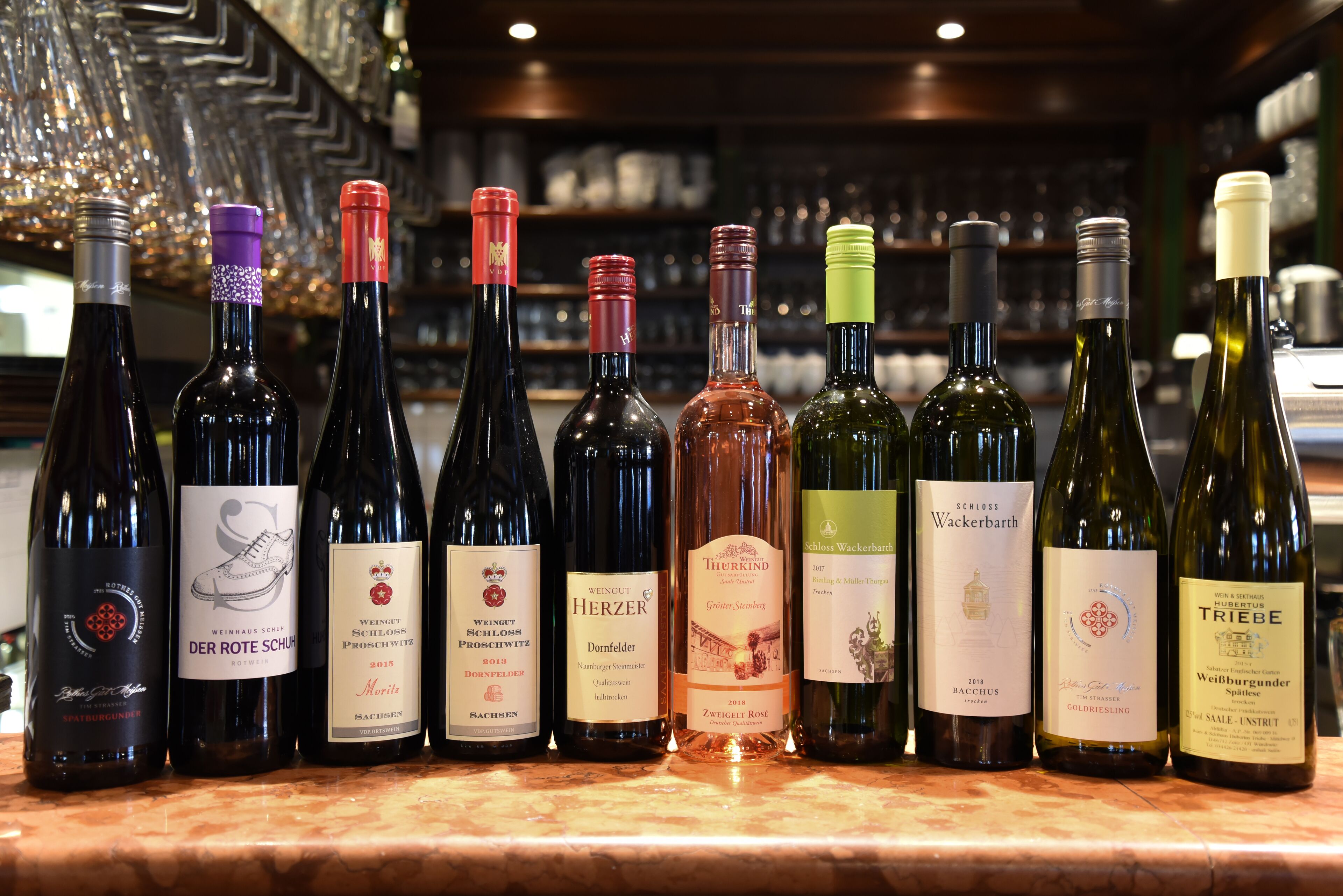 A selection of wine bottles on a bar counter.
