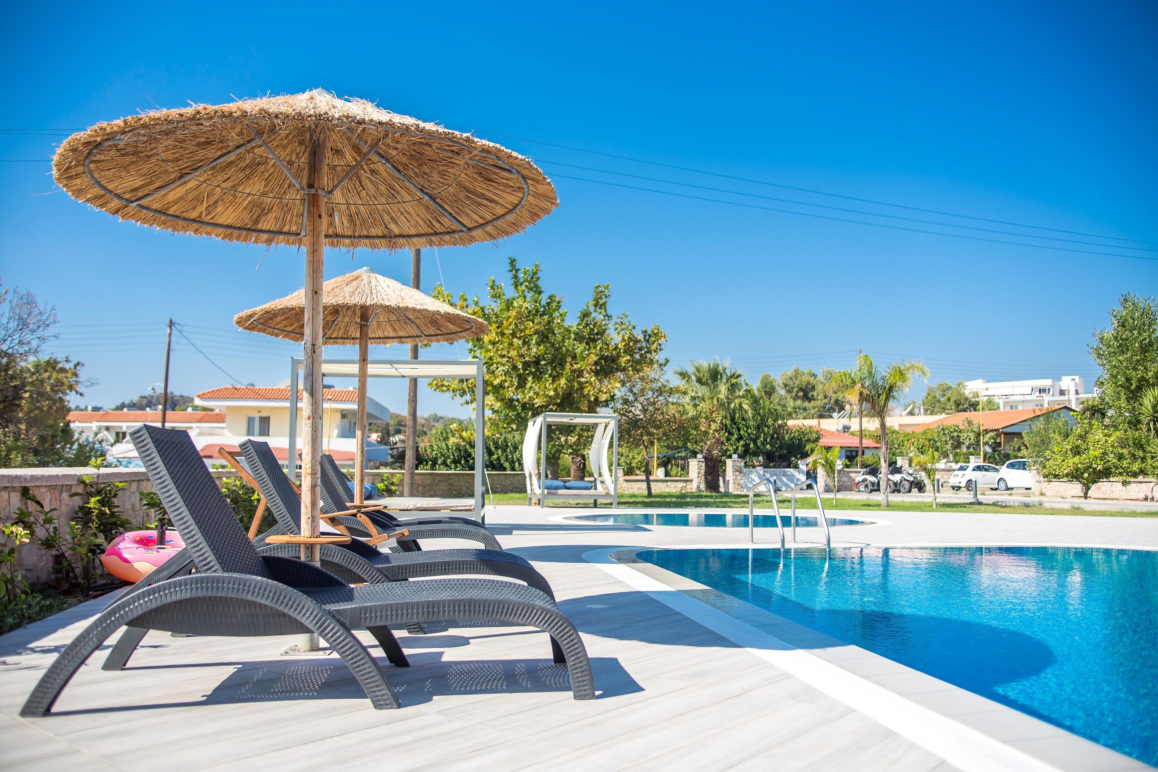 seasonal outdoor pool, pool umbrellas, pool loungers