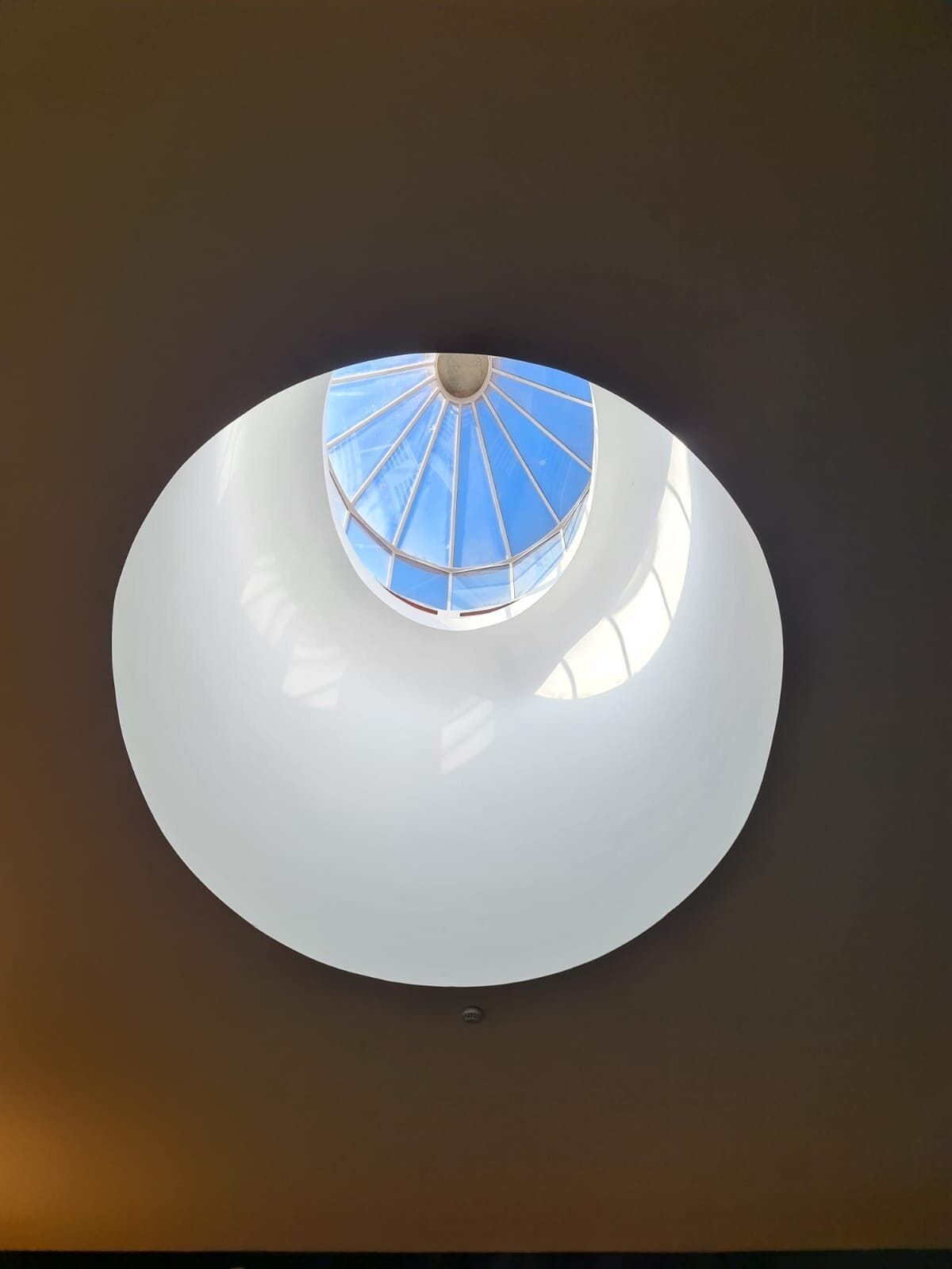 A circular ceiling with a central skylight.