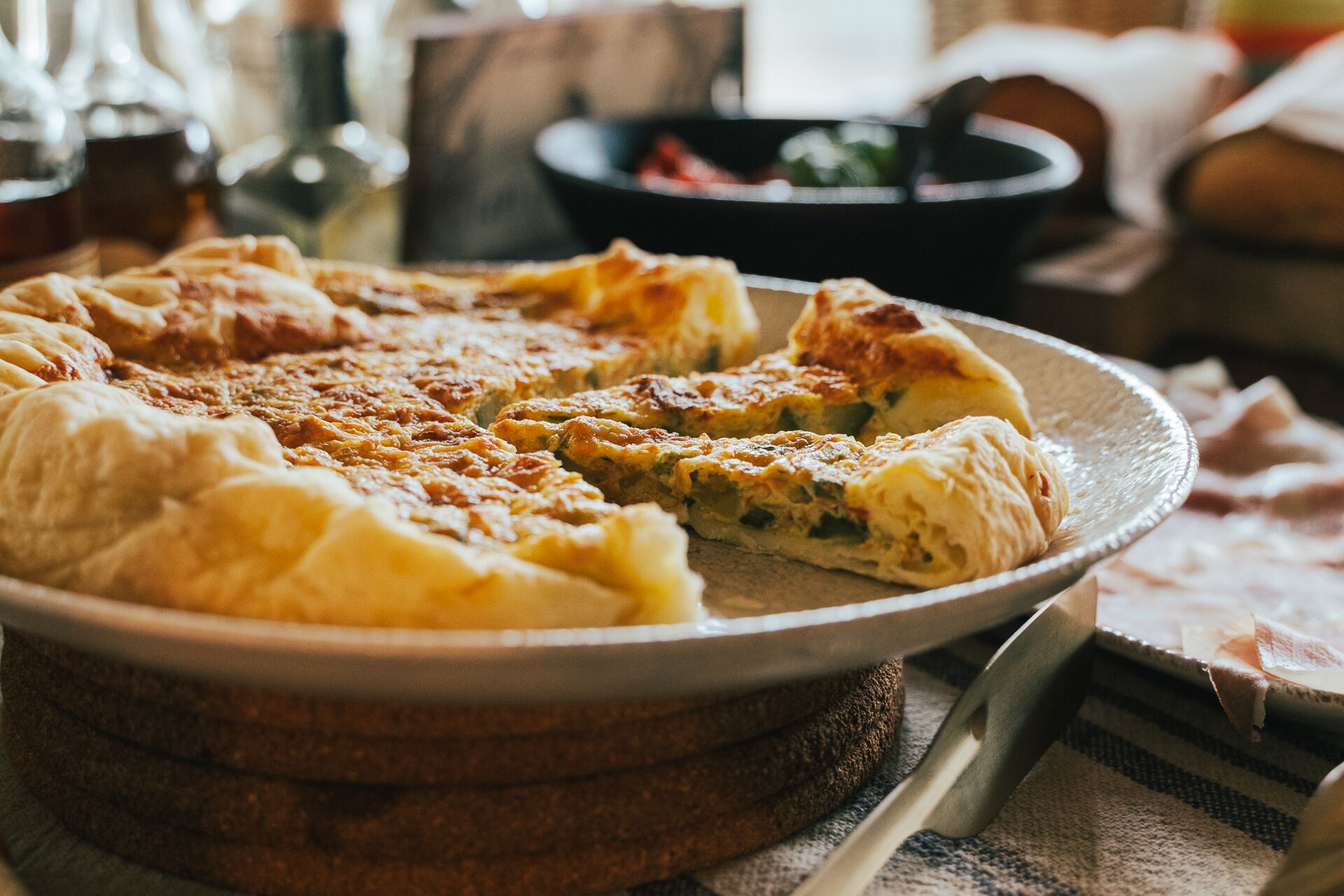 A pie on a plate with a slice missing.