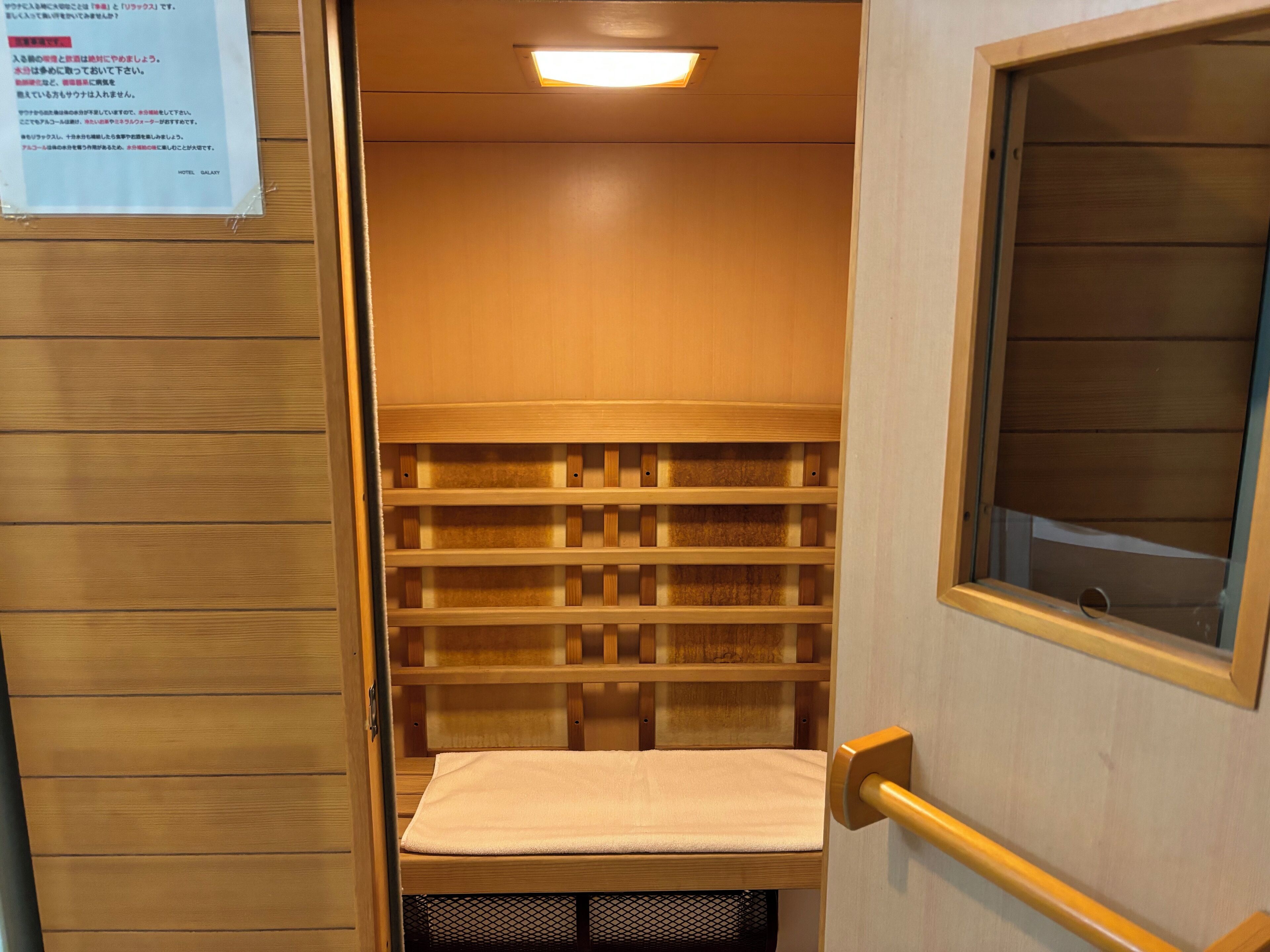 A wooden storage closet with shelves and a bench.
