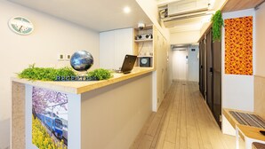 A reception area with a wooden counter, a clock, and a globe.