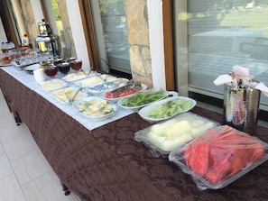 A buffet table with various food items and condiments.