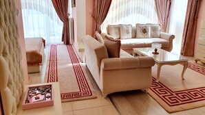 A living room with a sofa, armchairs, a coffee table, and a patterned rug. - Megas Palace Bankya (Sofia)