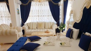 A luxurious bedroom with a large bed, a sofa, and a coffee table. - Megas Palace Bankya (Sofia)