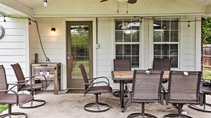 An outdoor patio with a table and chairs, a ceiling fan, and string lights. - 2 Mi to Lake McQueeny: Gem w/ Covered Patio (McQueeney)