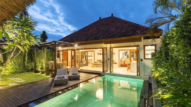 A modern house with a swimming pool, wooden deck, and lush greenery. - 2 Bedroom Villa in Seminyak Bali with private pool and enclosed Living Room. (Seminyak)