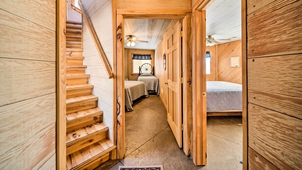 A wooden interior with a staircase leading to a bedroom. - Rustic Iowa Cabin: 10 Mi to Maquoketa Caves (Spragueville)