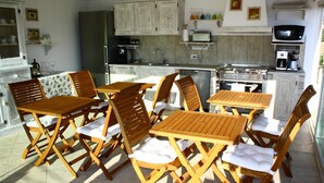 Una cocina compacta con mobiliario de madera, un refrigerador, un horno y un microondas.