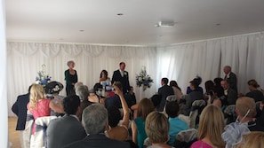 Host elegant events in this sophisticated space, featuring a draped backdrop and stylish decor.