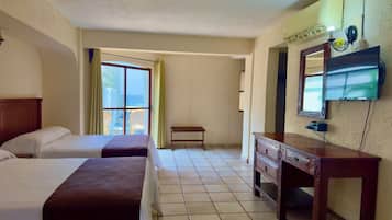 A hotel room with two beds, a wooden dresser, a bench, and a television mounted on the wall.