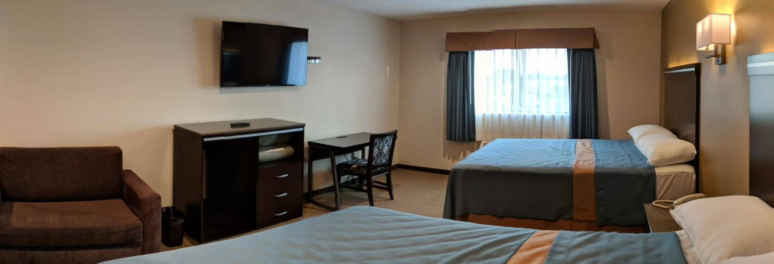 2 queen beds | desk, blackout curtains, iron/ironing board, free wifi