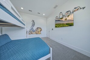 A bedroom with bunk beds, a mural, and a large window with a view. - Bright Chic Oasis with Private Pool and Spa at Reunion (Kissimmee)