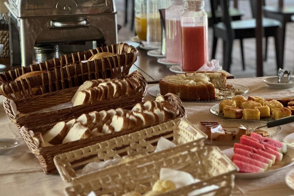 Et buffetbord med forskellige kager og desserter, herunder kager og frugtforslag.