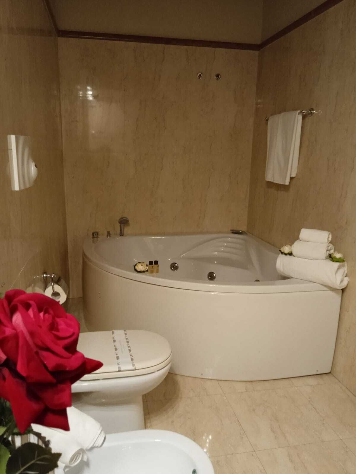 A bathroom with a bathtub, toilet, and sink.
