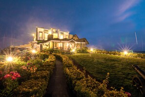 A large, modern house with a well-maintained garden and a pathway leading to the entrance. - The Forest and lake by Schofieldshire (Nuwara Eliya)