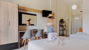 A hotel room with a bed, a desk, two chairs, a television, and a wardrobe. - Riposo Studios & Apartments (Corfu)