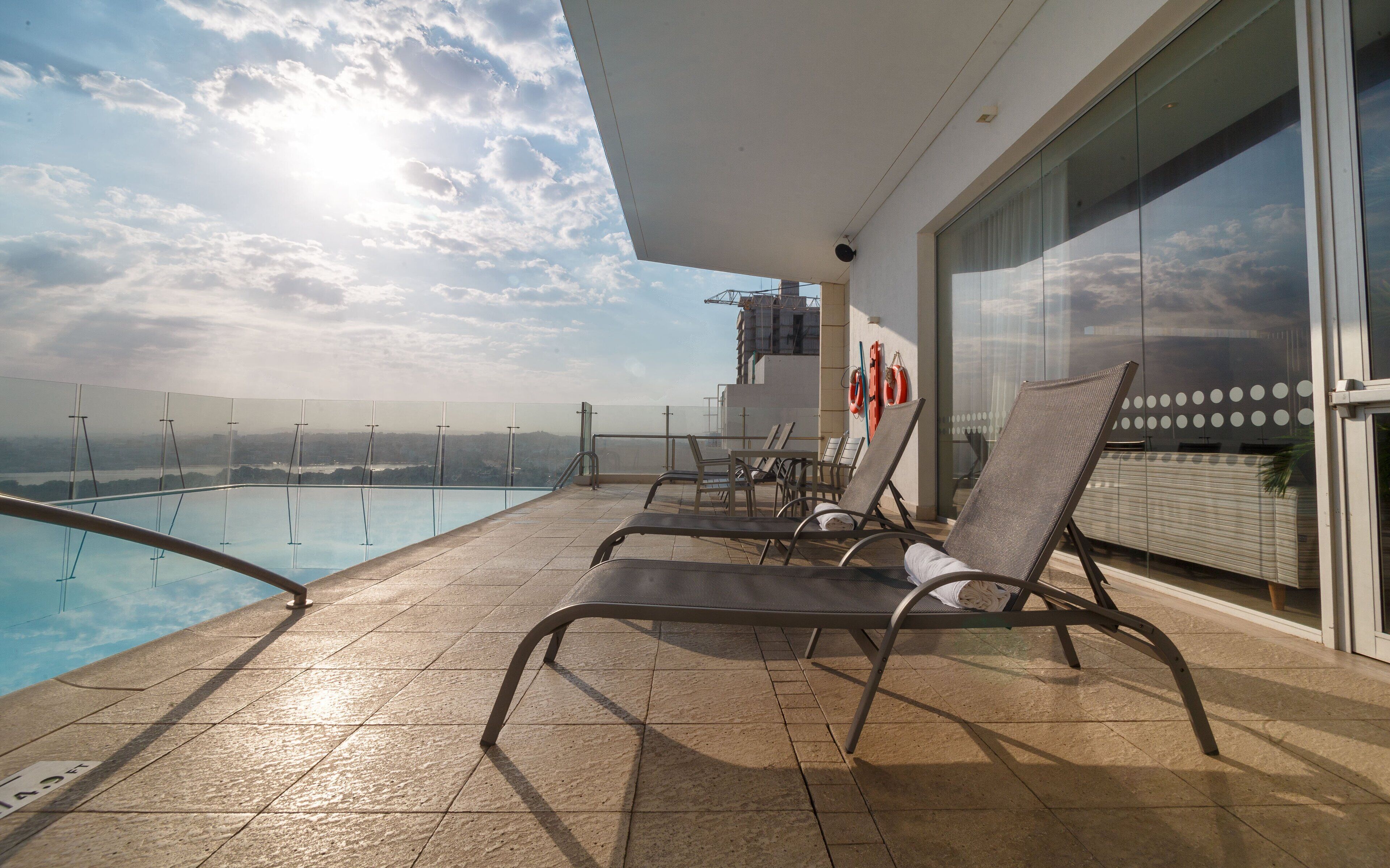 outdoor pool, open 8:00 am to 8:00 pm, pool loungers