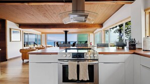 A modern kitchen with a stainless steel stove, oven, and a glass cooktop. - Newly Renovated Oceanfront Retreat in Bolinas with Spa and huge fenced yard  (Bolinas)