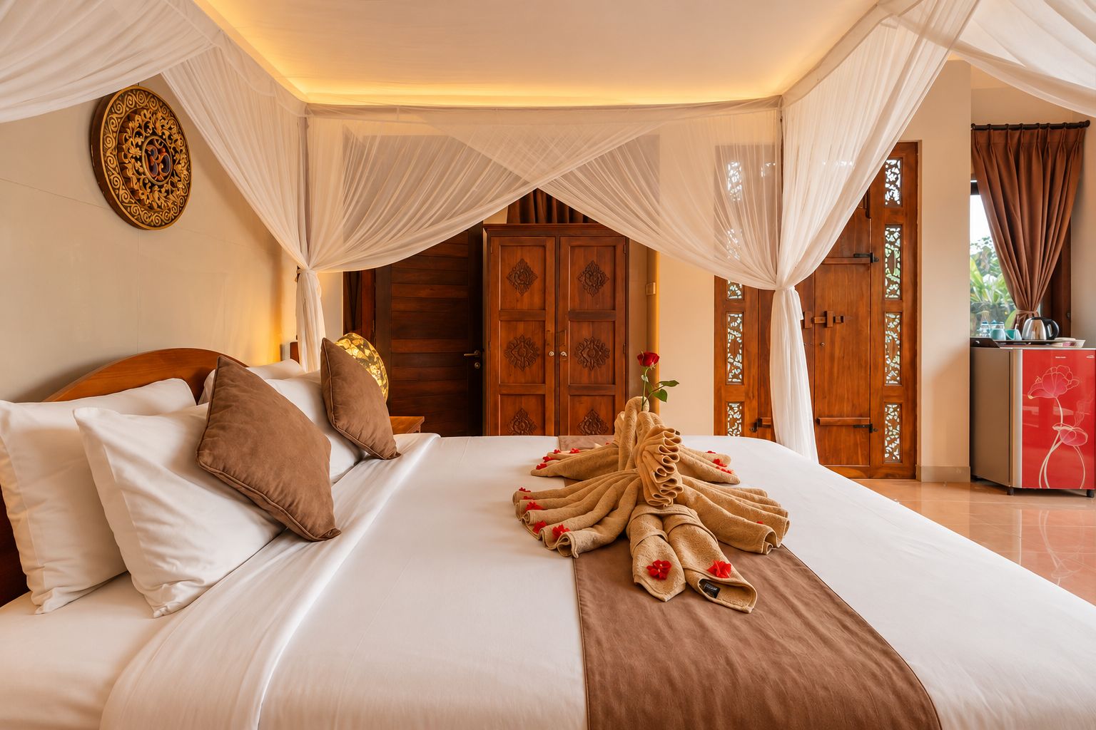 A hotel room with a bed, pillows, a decorative wall piece, and a neatly arranged towel with a rose.
