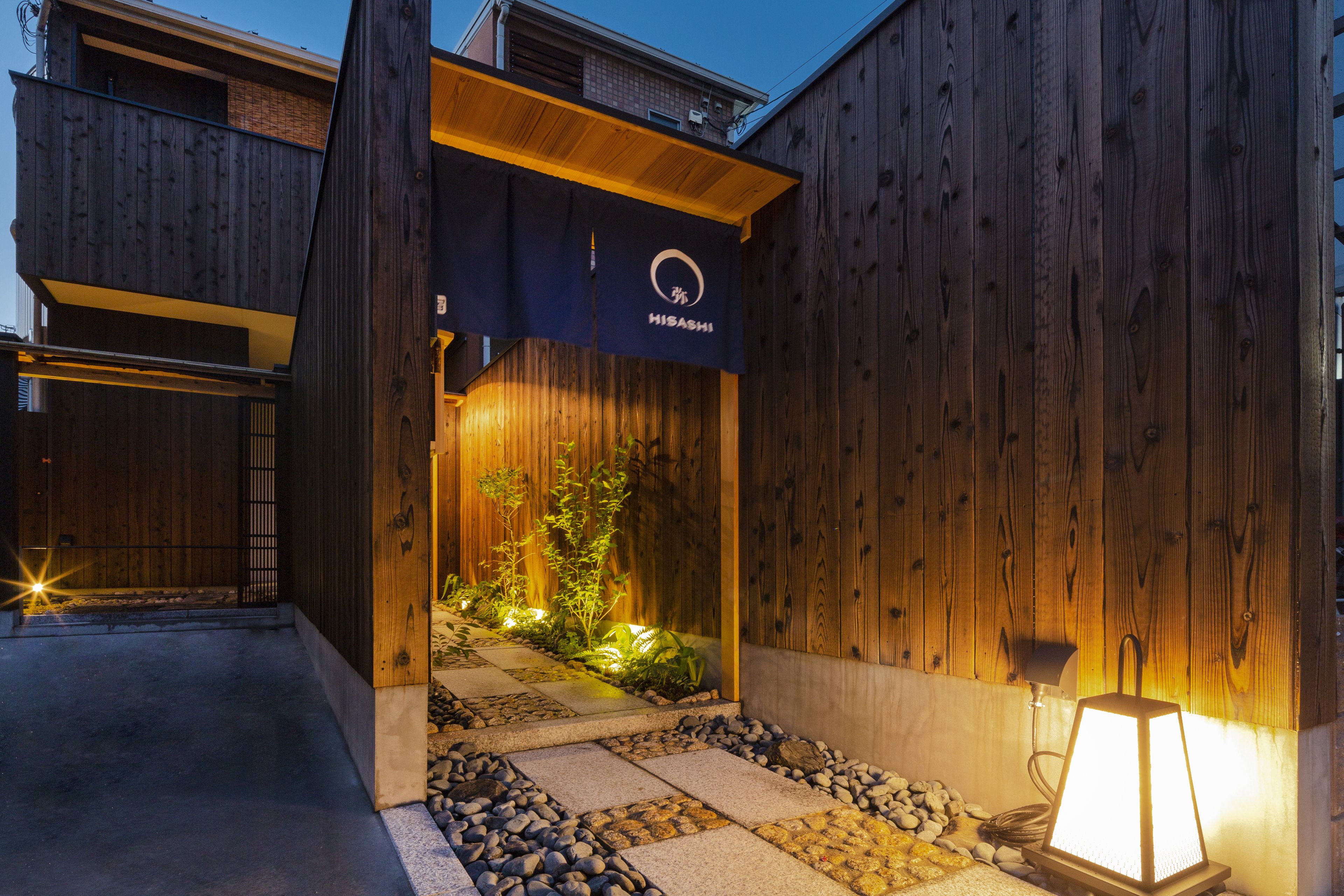 A wooden exterior with a sign reading "HISASHI".