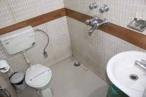 A small bathroom with a toilet, bidet, and sink.