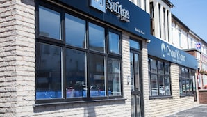 A building with a sign for 'DJ Suites' and 'Chai Khana' on the facade.