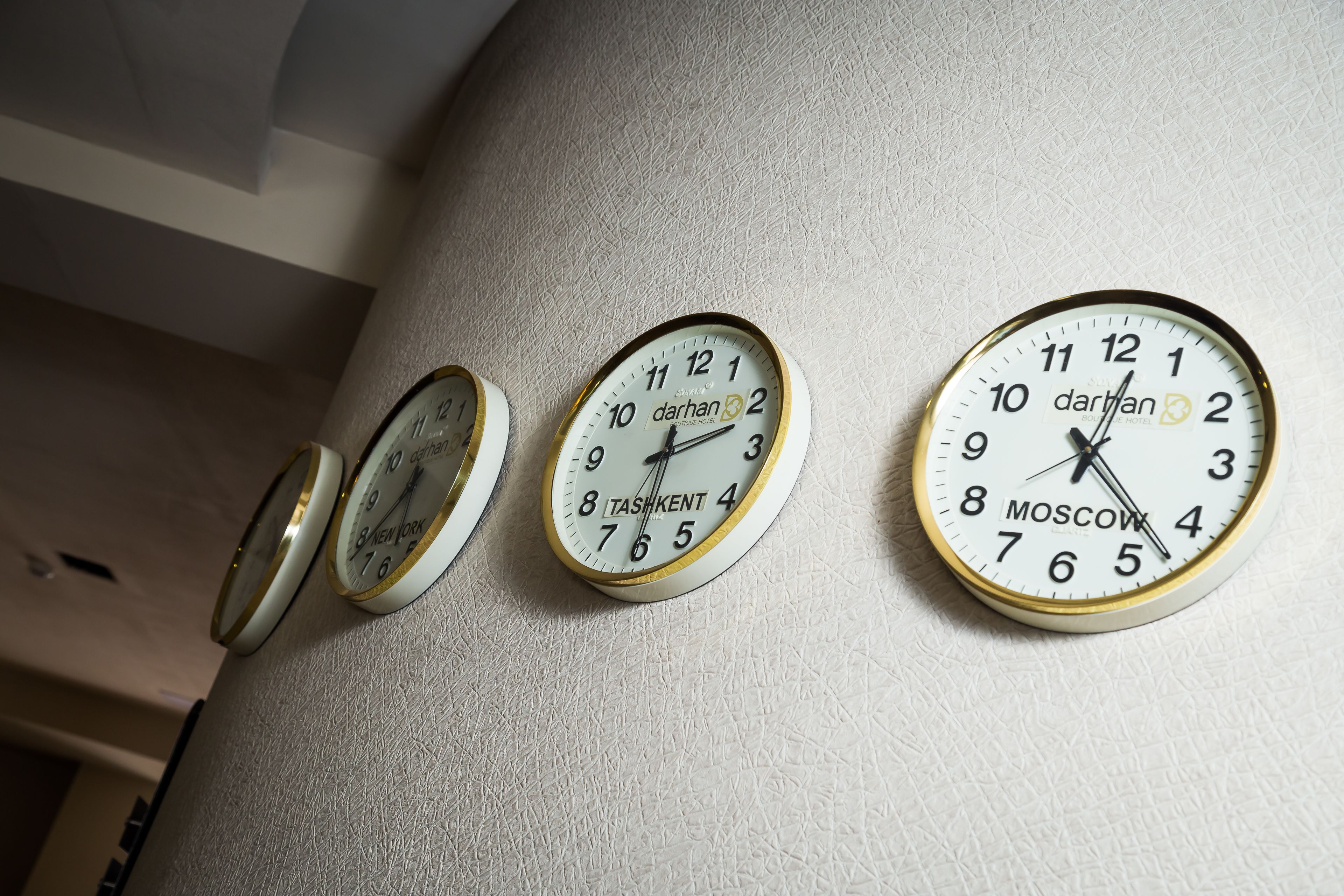 Three wall clocks with different brands and designs.