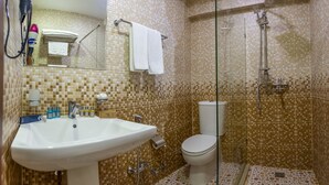 A bathroom with a white sink, toilet, and shower area. - Hotel 28 (Baku)